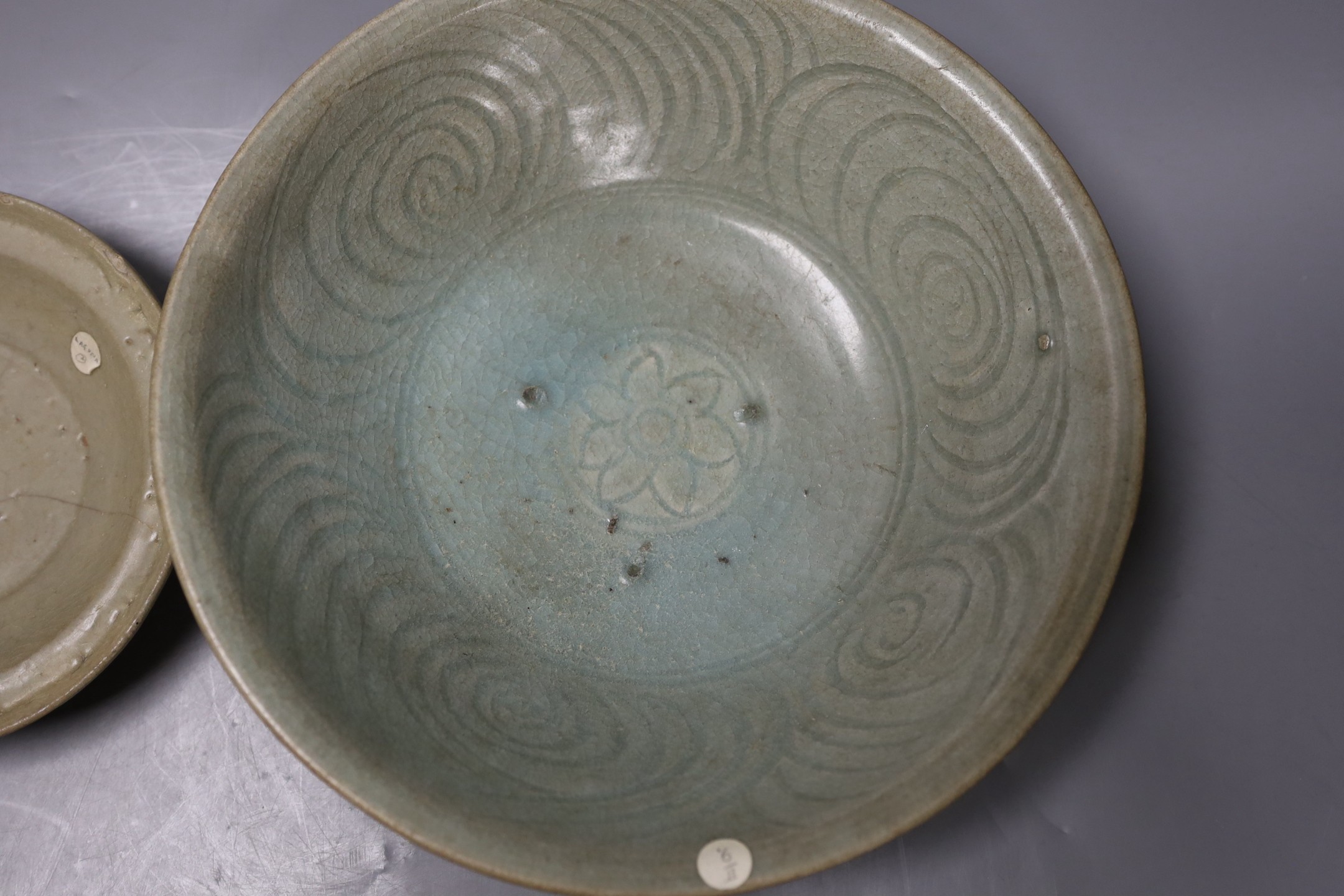 A Chinese celadon dish, probably Southern Song Dynasty, 17.5cm and a Thai Sawankhalok celadon deep dish, 16th century, largest 27cm